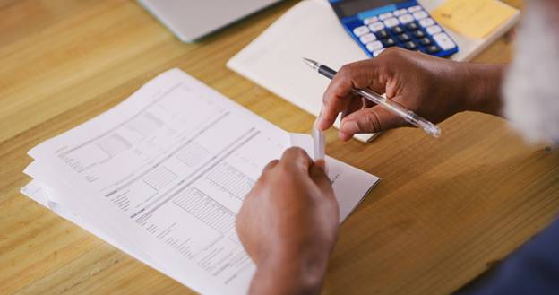 Woman sorting paperwork - Paystubs